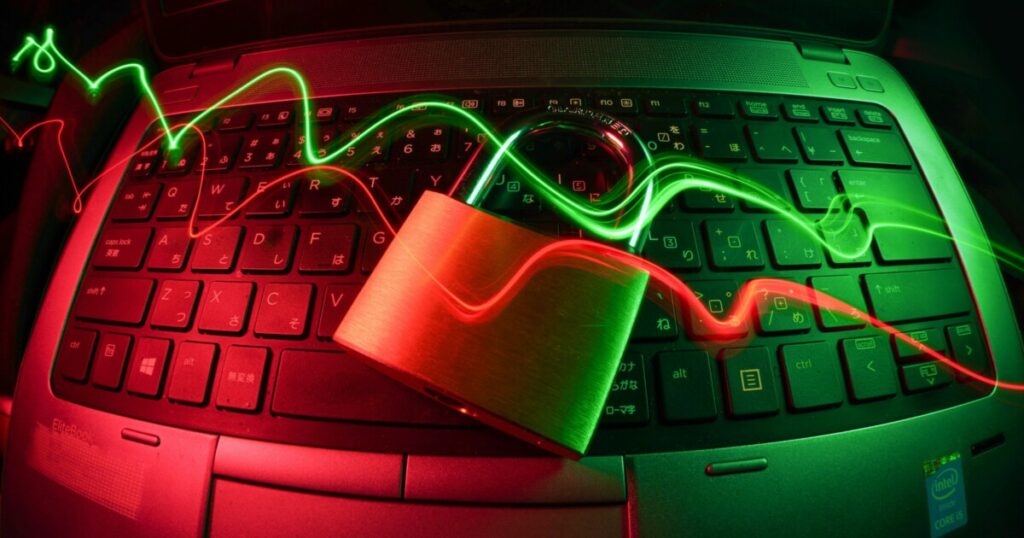 Padlock resting on a laptop keyboard, illustrating cybersecurity for churches against AI-driven threats
