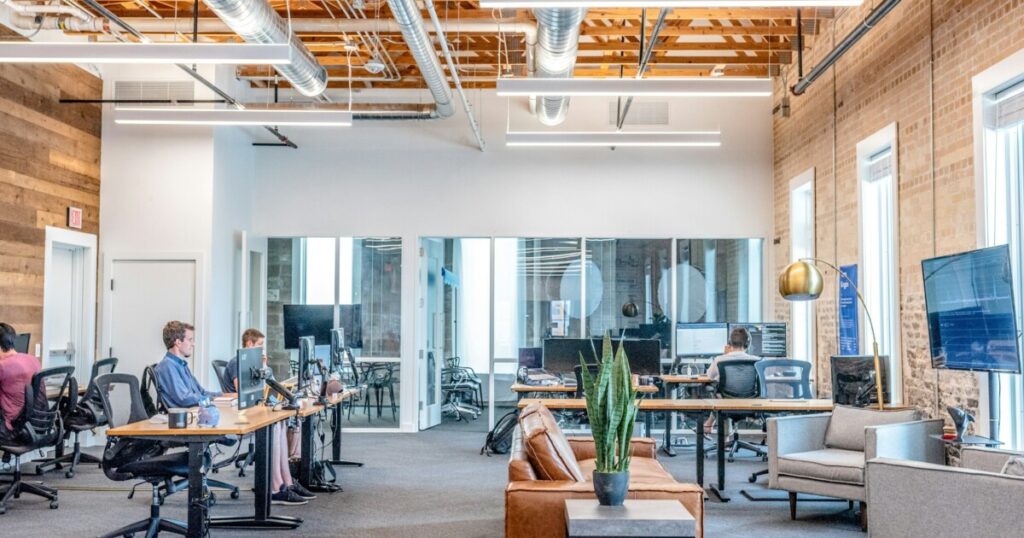 Employees working at computer workstations in a small business office